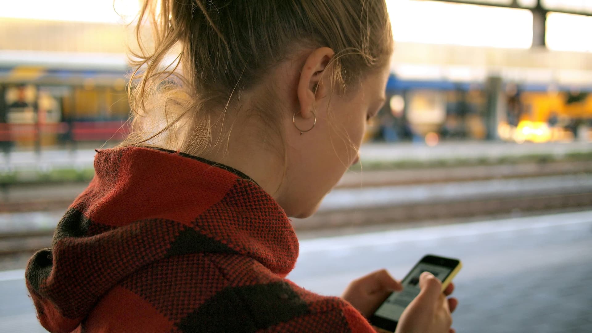 Smartphone displaying a dating app interface with a blurred contact information field, emphasizing privacy.