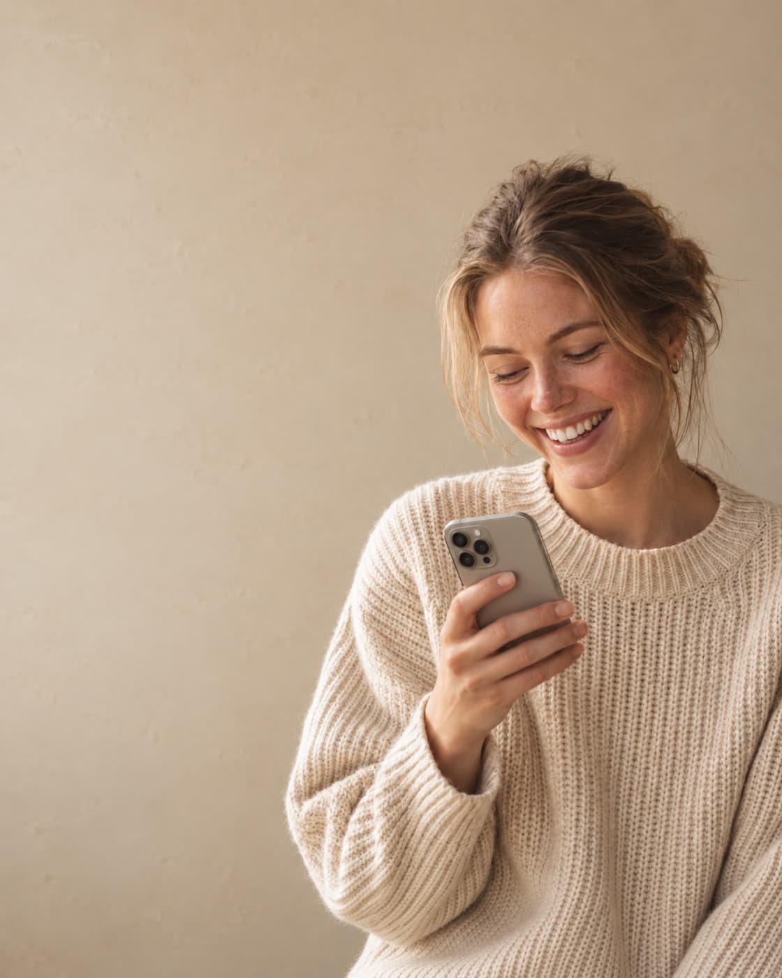Person laughing while texting on their phone
